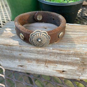 Small Navajo concho on old horse rein leather bracelet